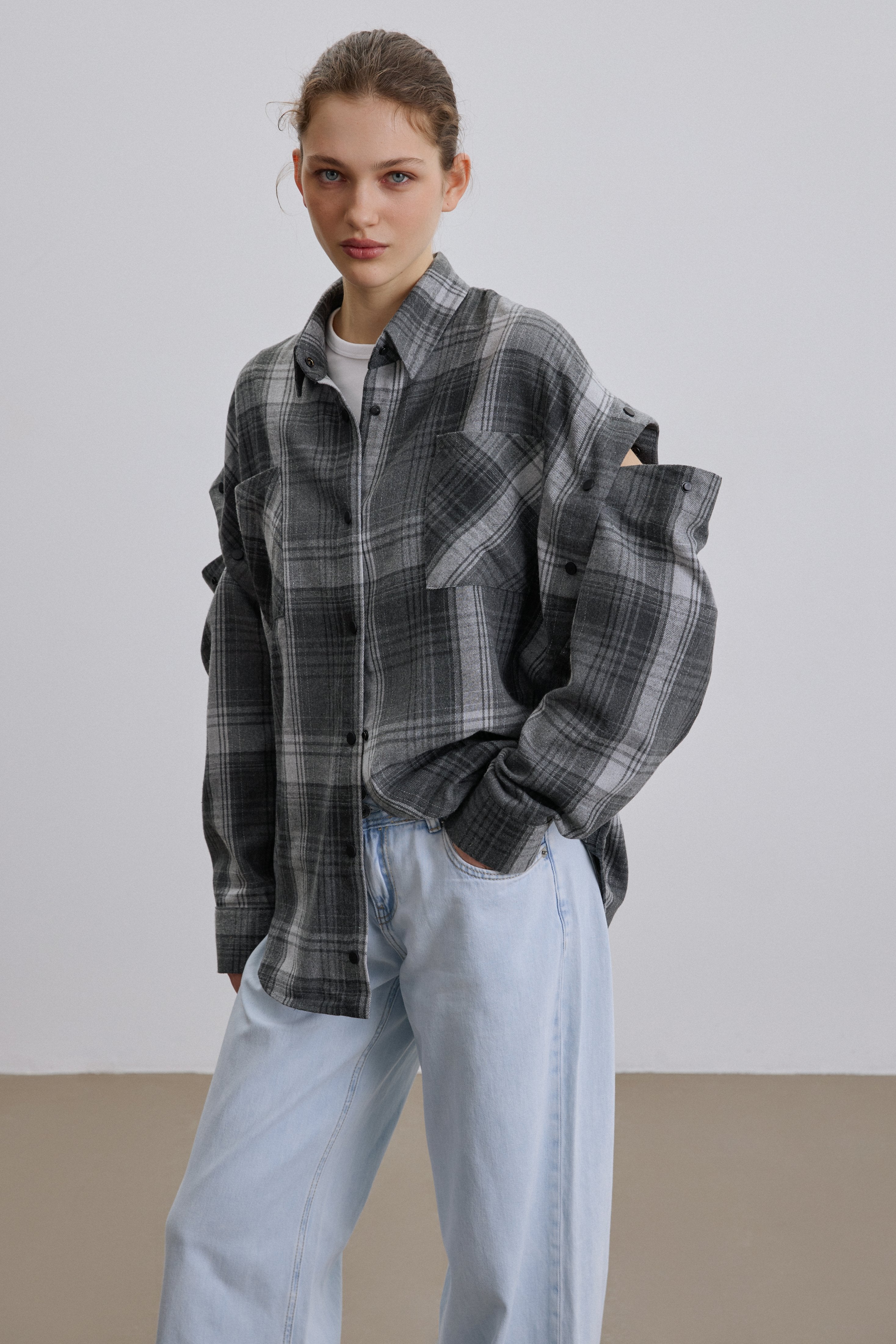 Grey checkered shirt shown with sleeves.