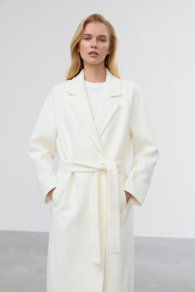 Details of waist belt on milky beige bucket coat.