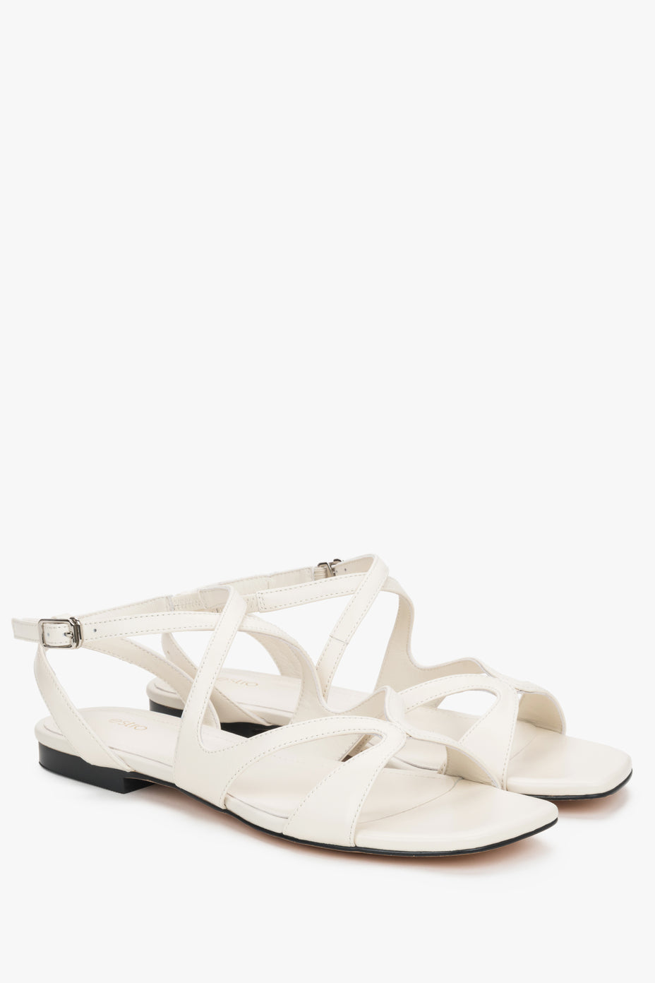 Milky beige strappy sandals with flat sole.