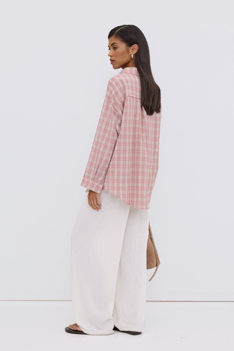 Close-up of buttons and light pink plaid pattern.