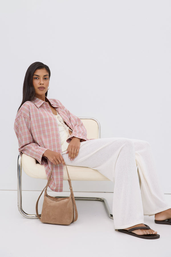 lose-up of soft light pink plaid fabric texture.