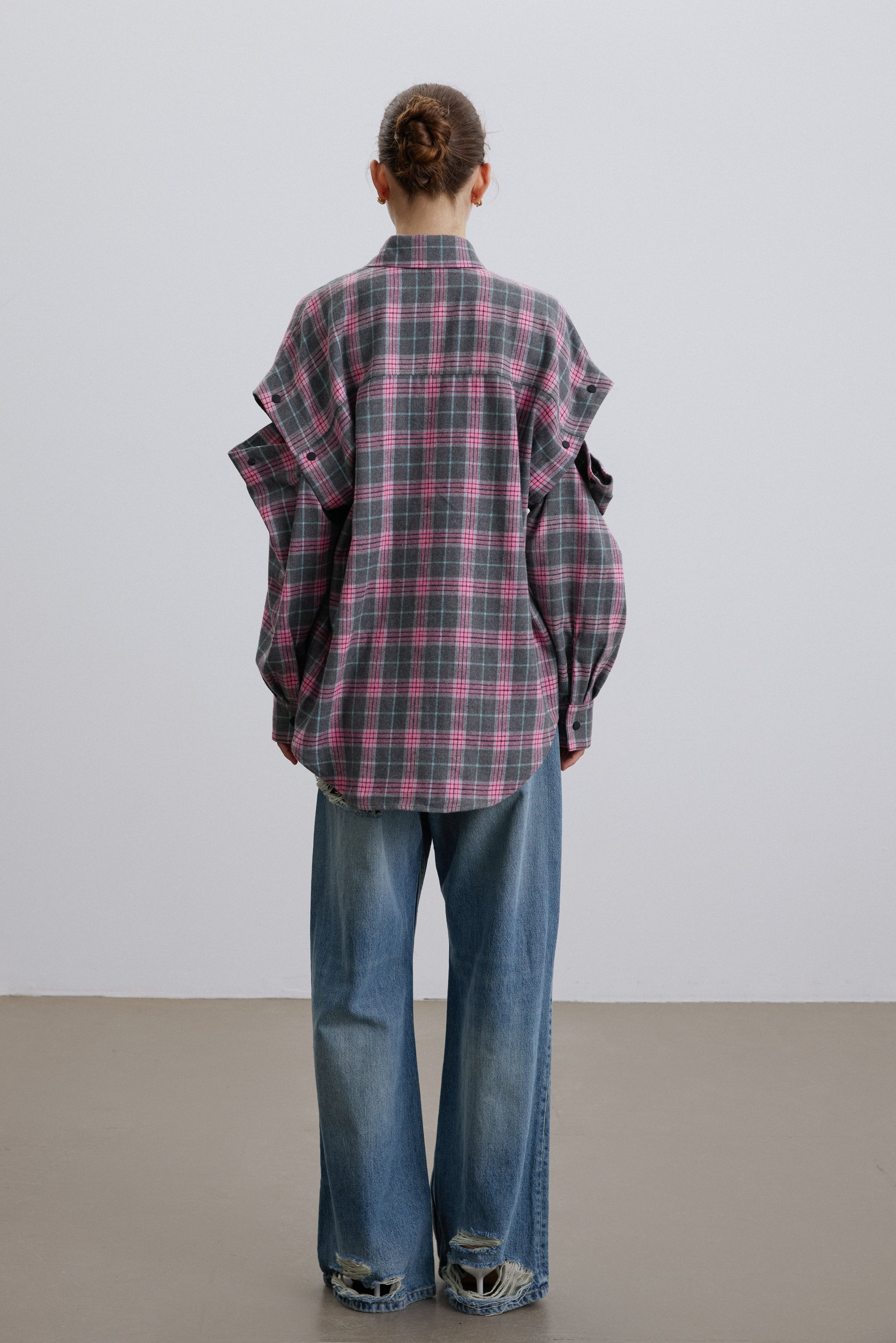 Back of women’s pink and grey checkered shirt.