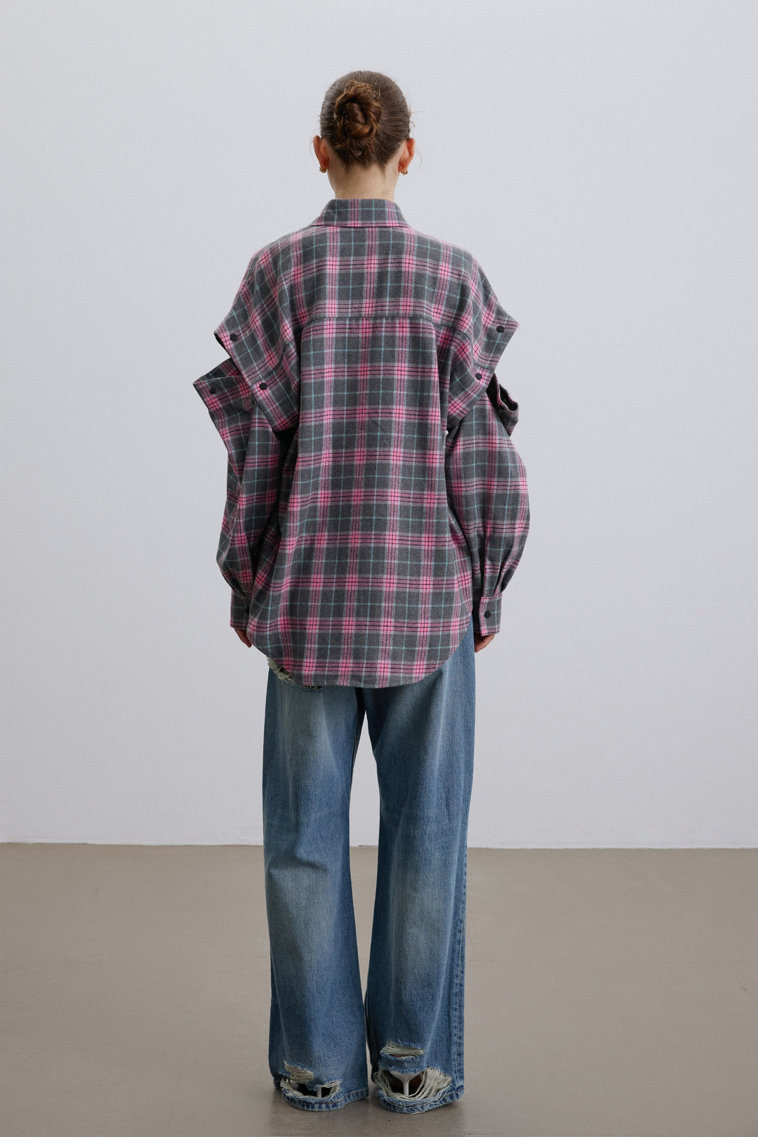 Back of women’s pink and grey checkered shirt.