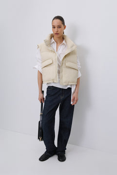 Model wearing Estro short light beige puffer vest.