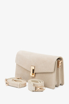 Close-up of soft light beige natural velour texture.