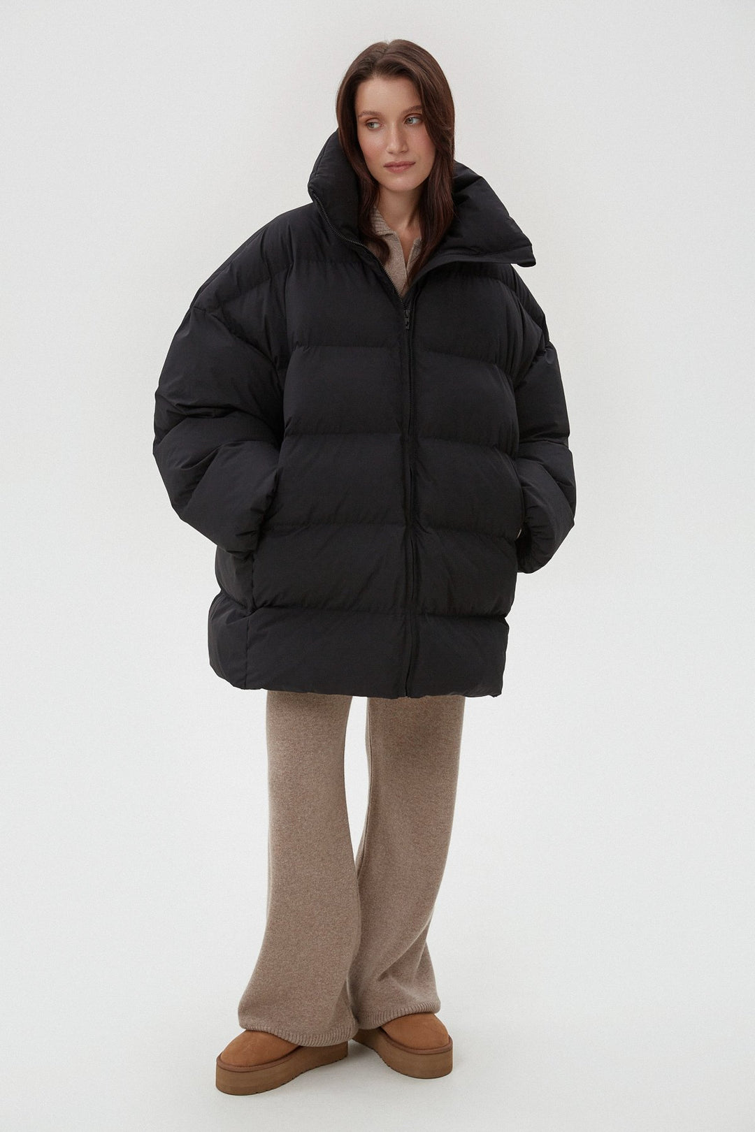 Women's black puffer jacket by Estro.