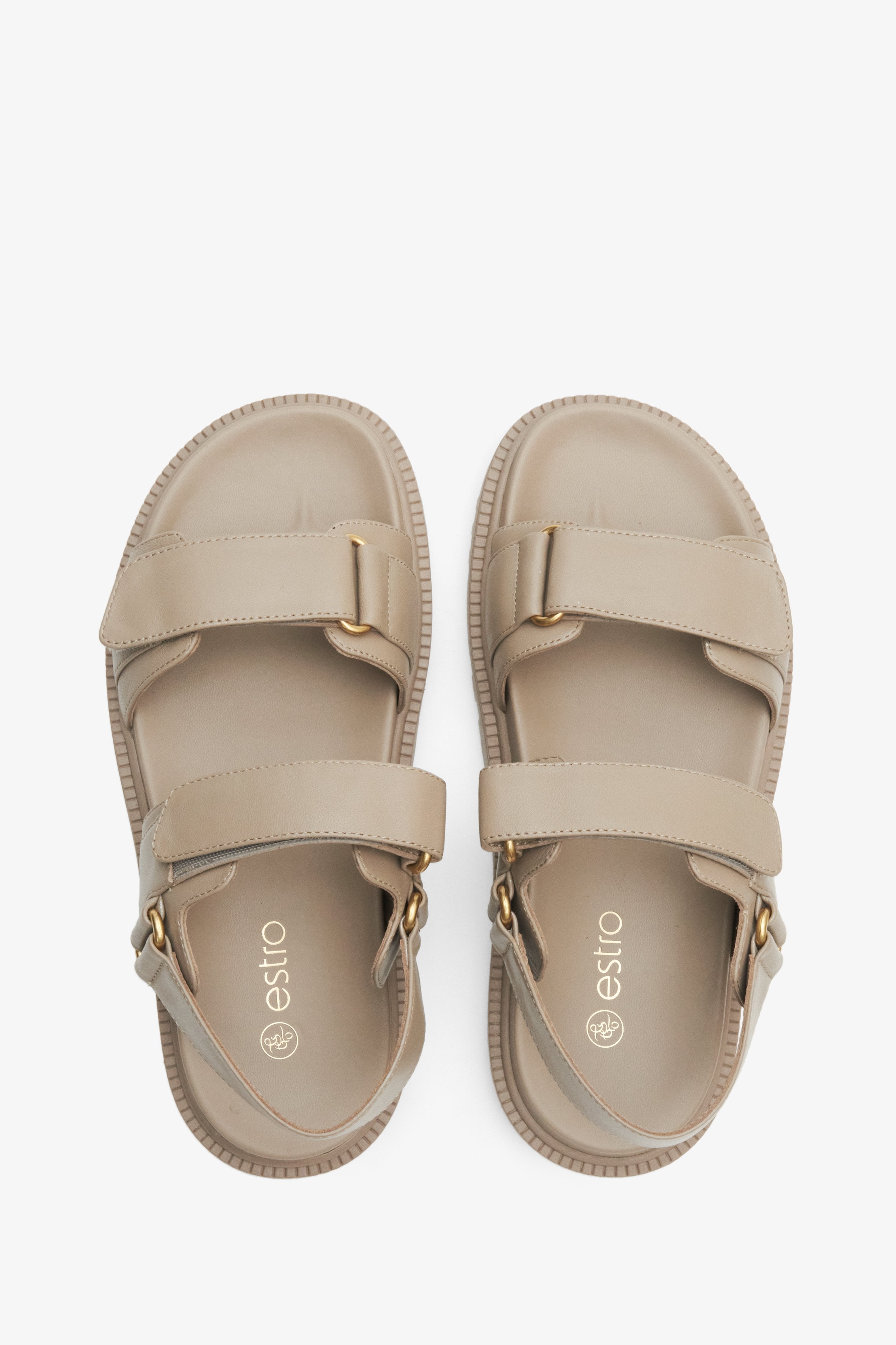 Women's beige sandals made of genuine leather with a flexible sole and golden elements.