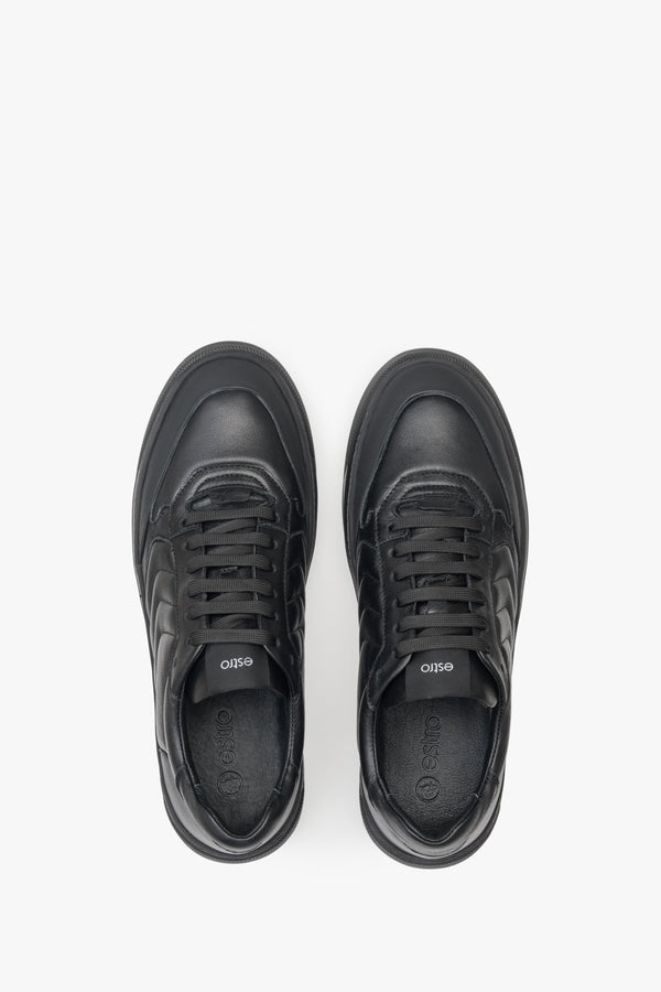 Low, lace-up men's sneakers made from genuine black leather by Estro - close-up of the upper part of the shoes.