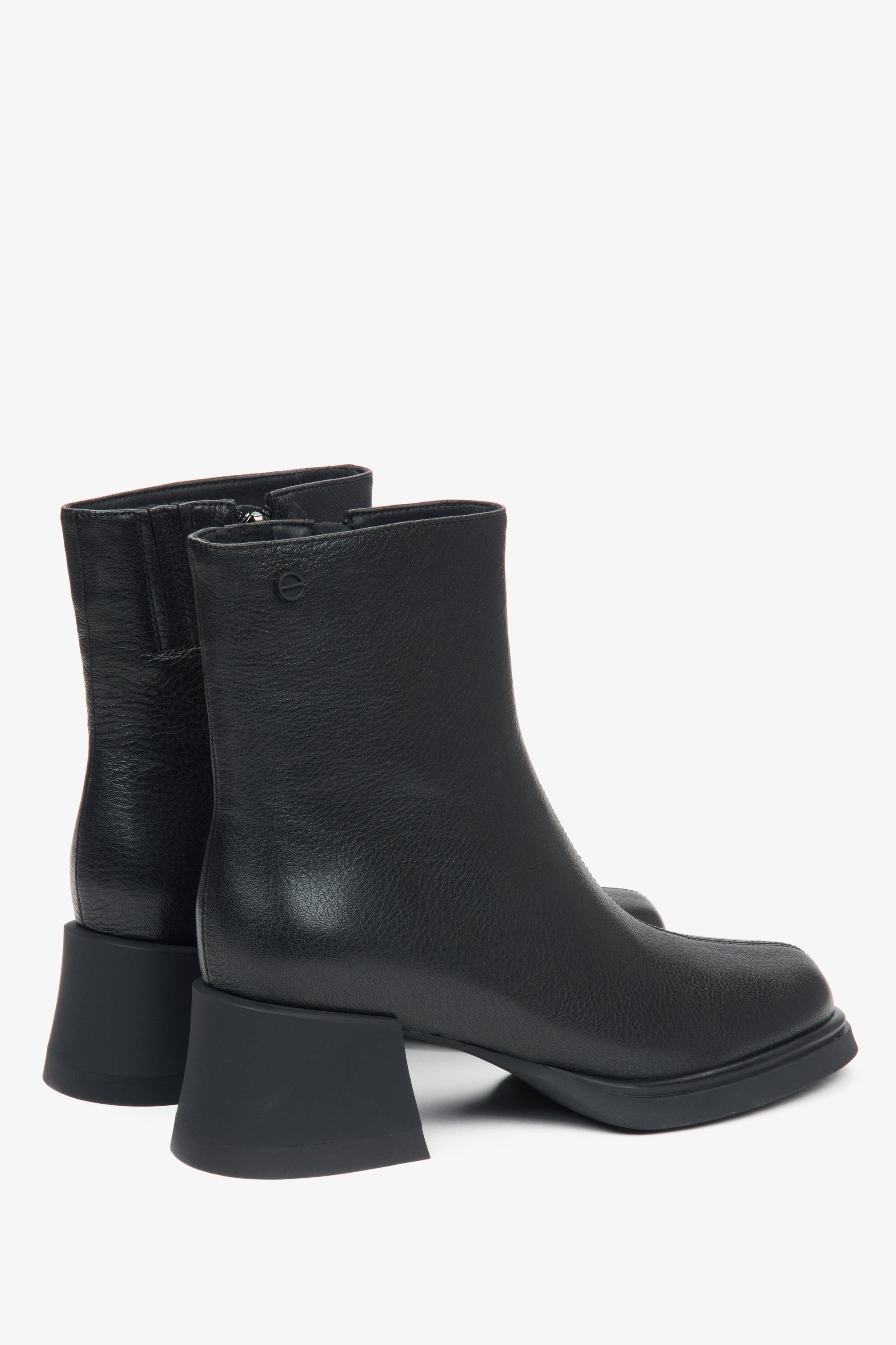 Women's black leather ankle boots with a block heel by Estro - close-up on the heel.