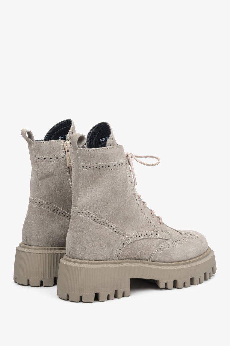 Women's grey suede ankle boots with decorative lacing - close-up of the side and heel lines of the boots.