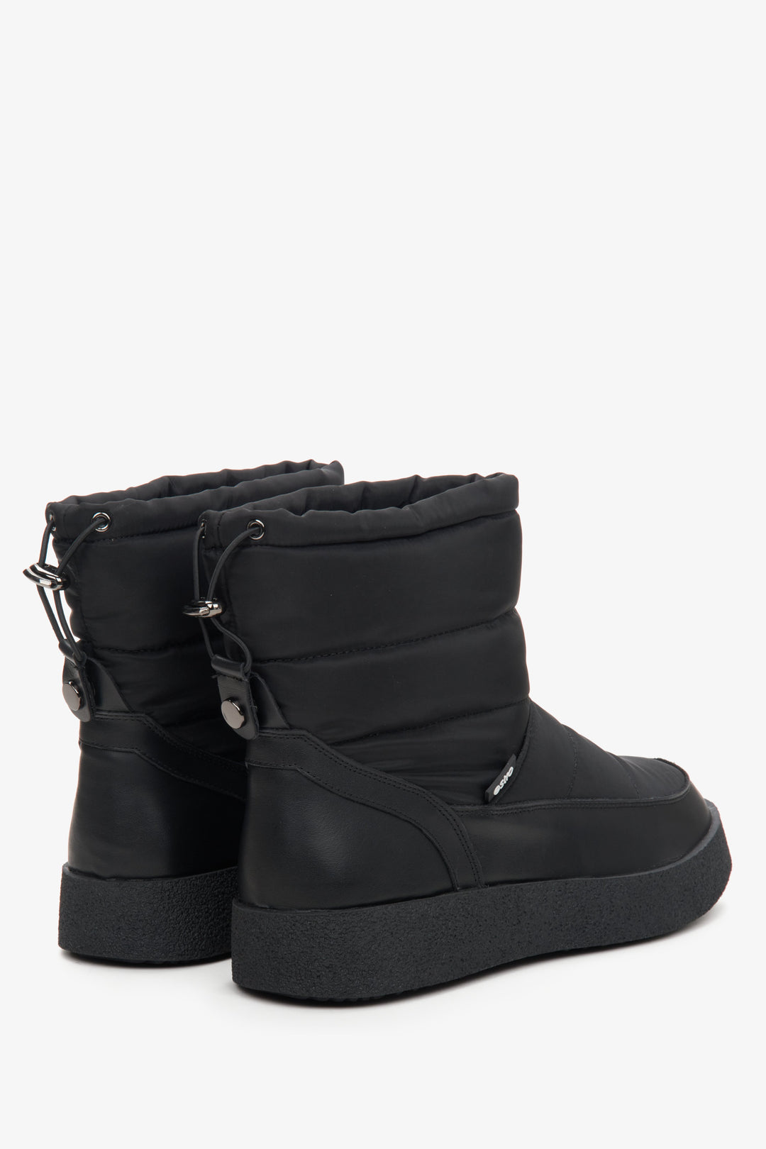 Women's black snow boots made of genuine leather and fur - close-up on the side line and heel.