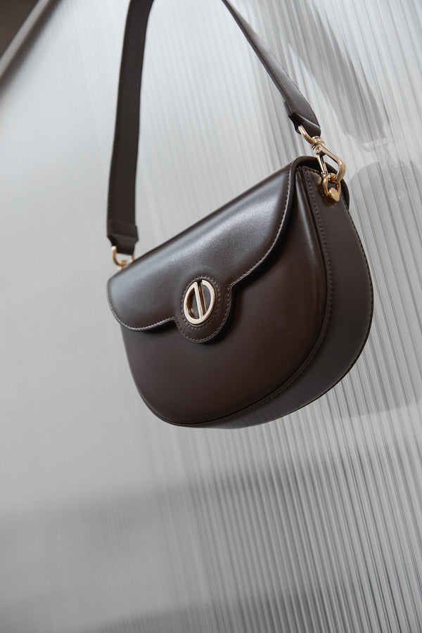 Women's dark brown shoulder bag with golden accents by Estrо.