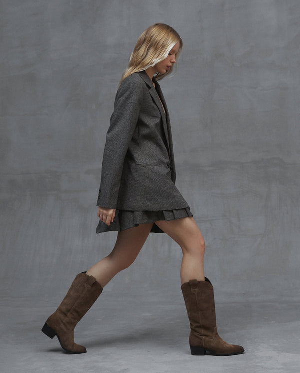 Women's brown suede cowboy boots by Estro for fall - presentation on a model.