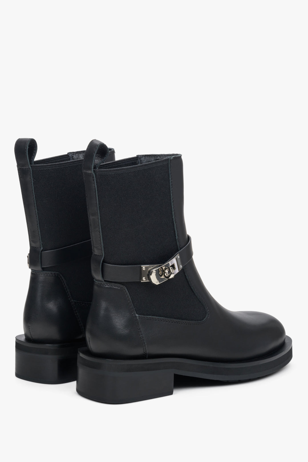 Women's ankle boots with decorative strap in black by Estro - close-up on the heel and side line of the shoe.