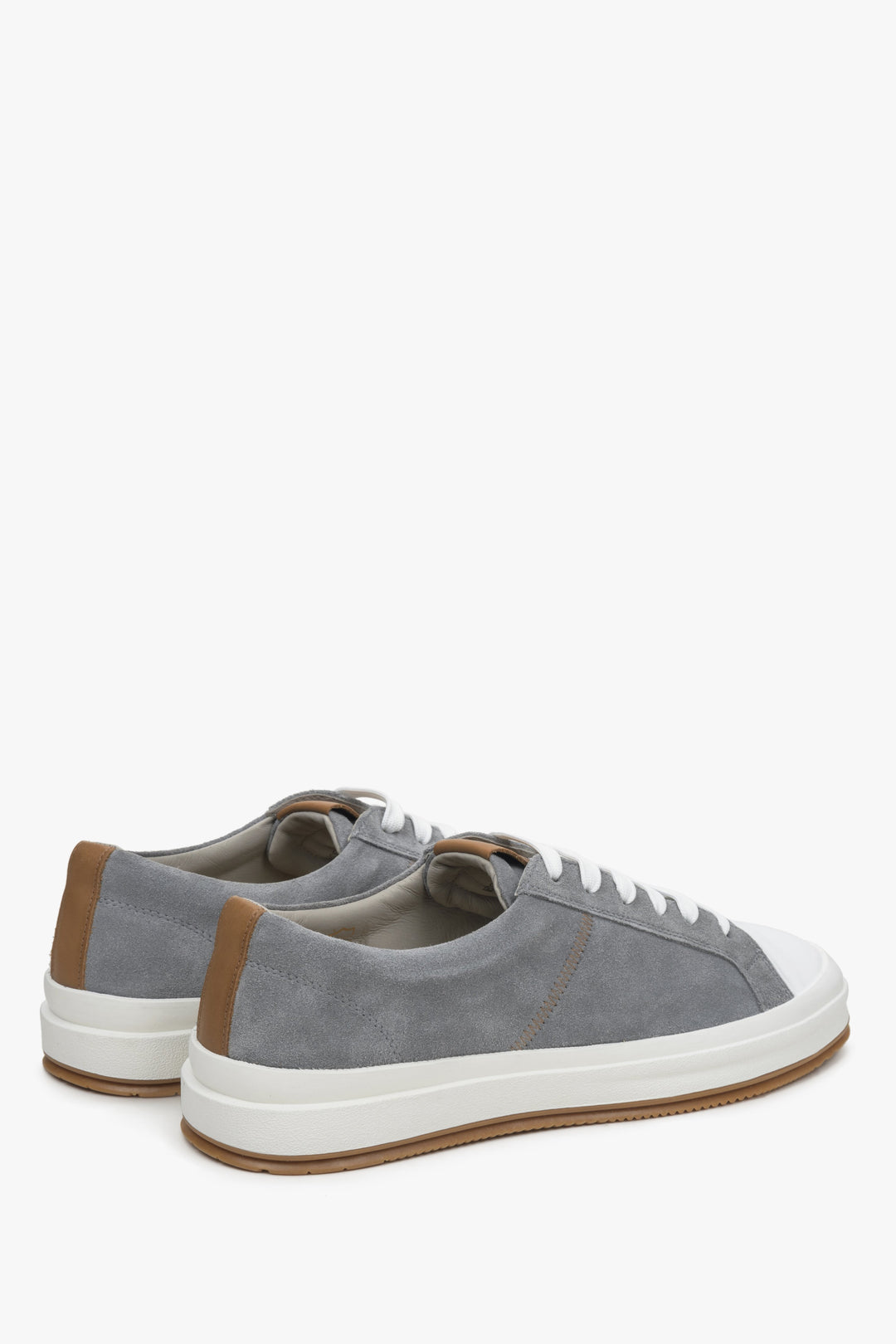 Men's grey sneakers made of genuine velour - close-up on the heel and side line of the shoes.