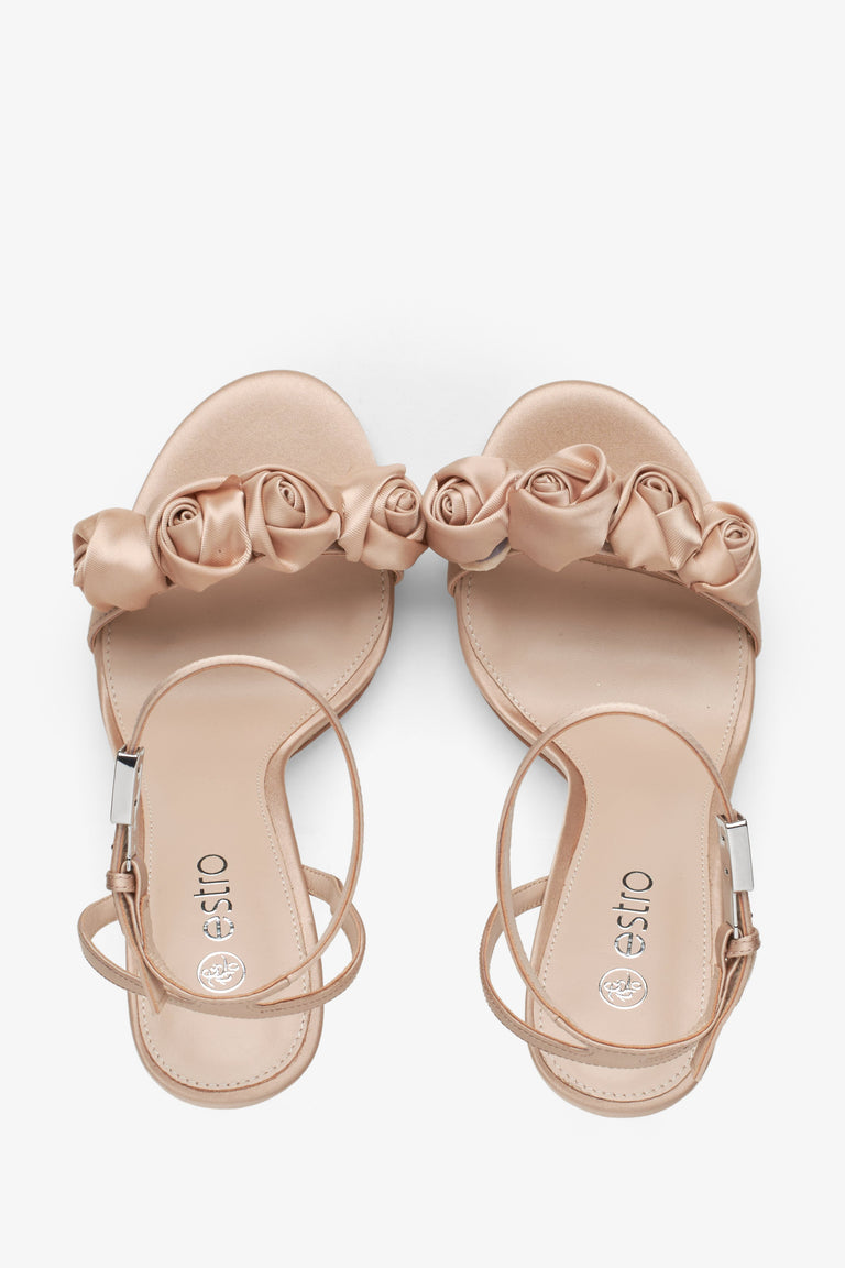 Women's beige sandals with floral ornamented heels - top view presentation.