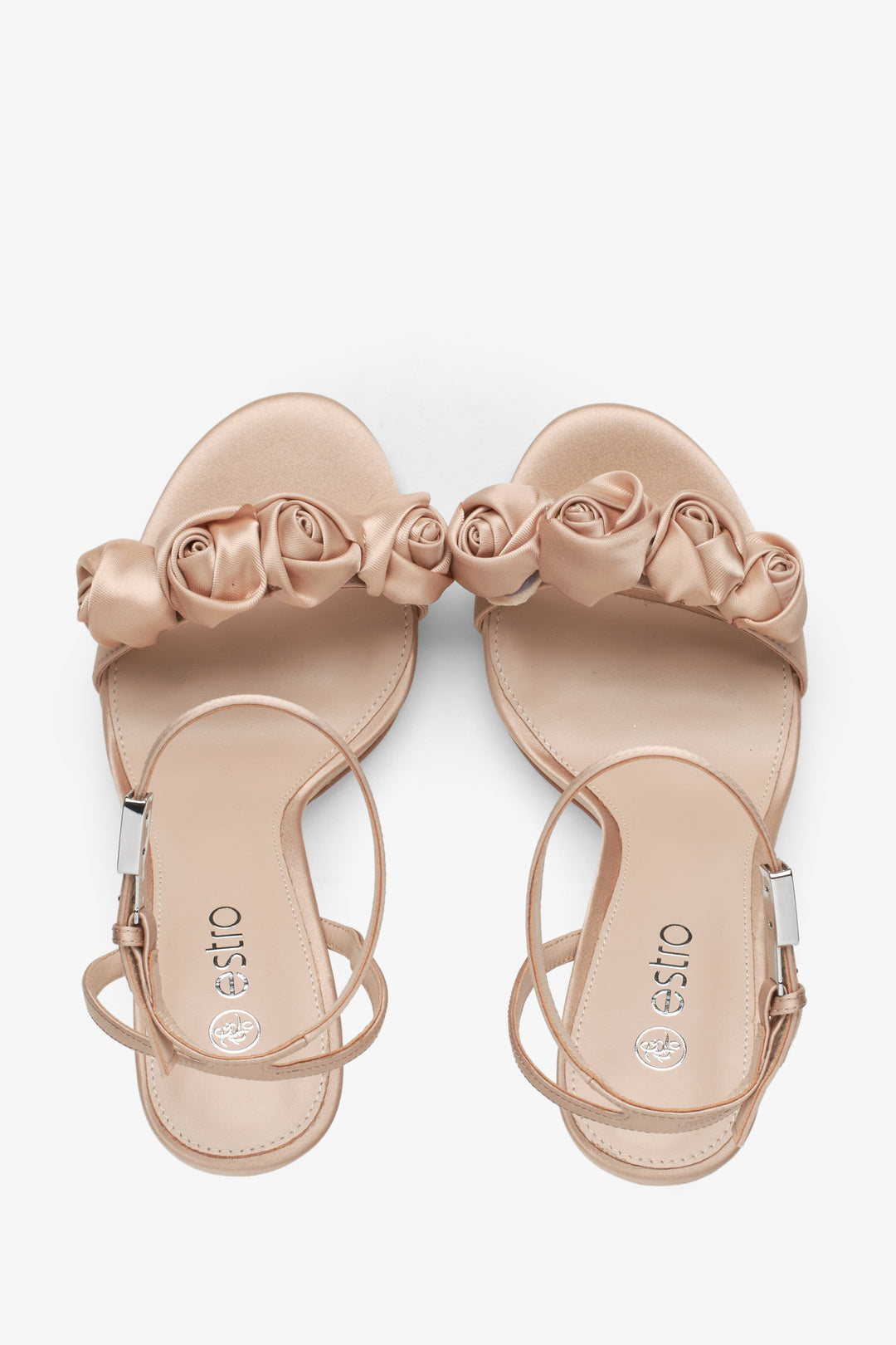 Women's beige sandals with floral ornamented heels - top view presentation.