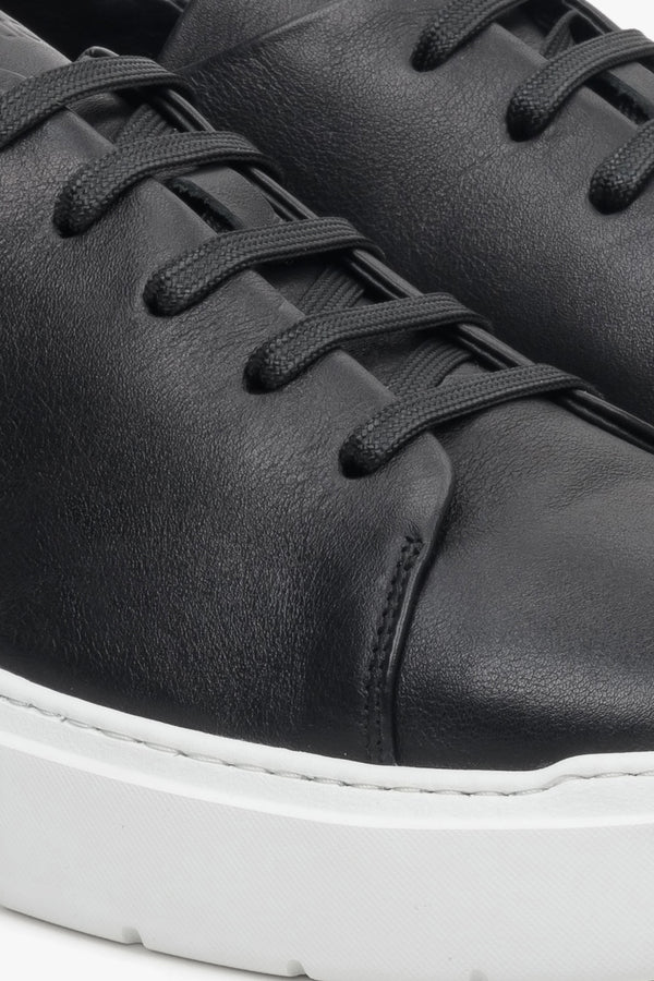 Black leather men's sneakers with laces by Estro - close-up on the details.