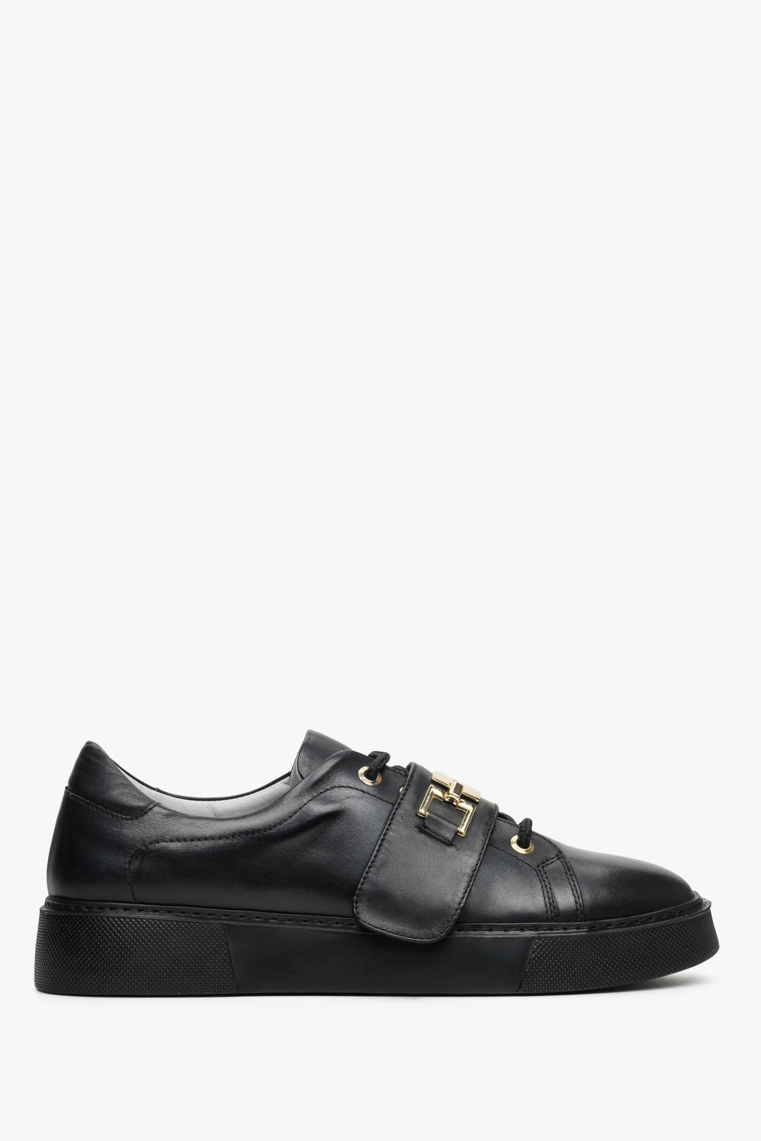 Women's black leather sneakers by Estro with a gold embellishment - shoe profile.