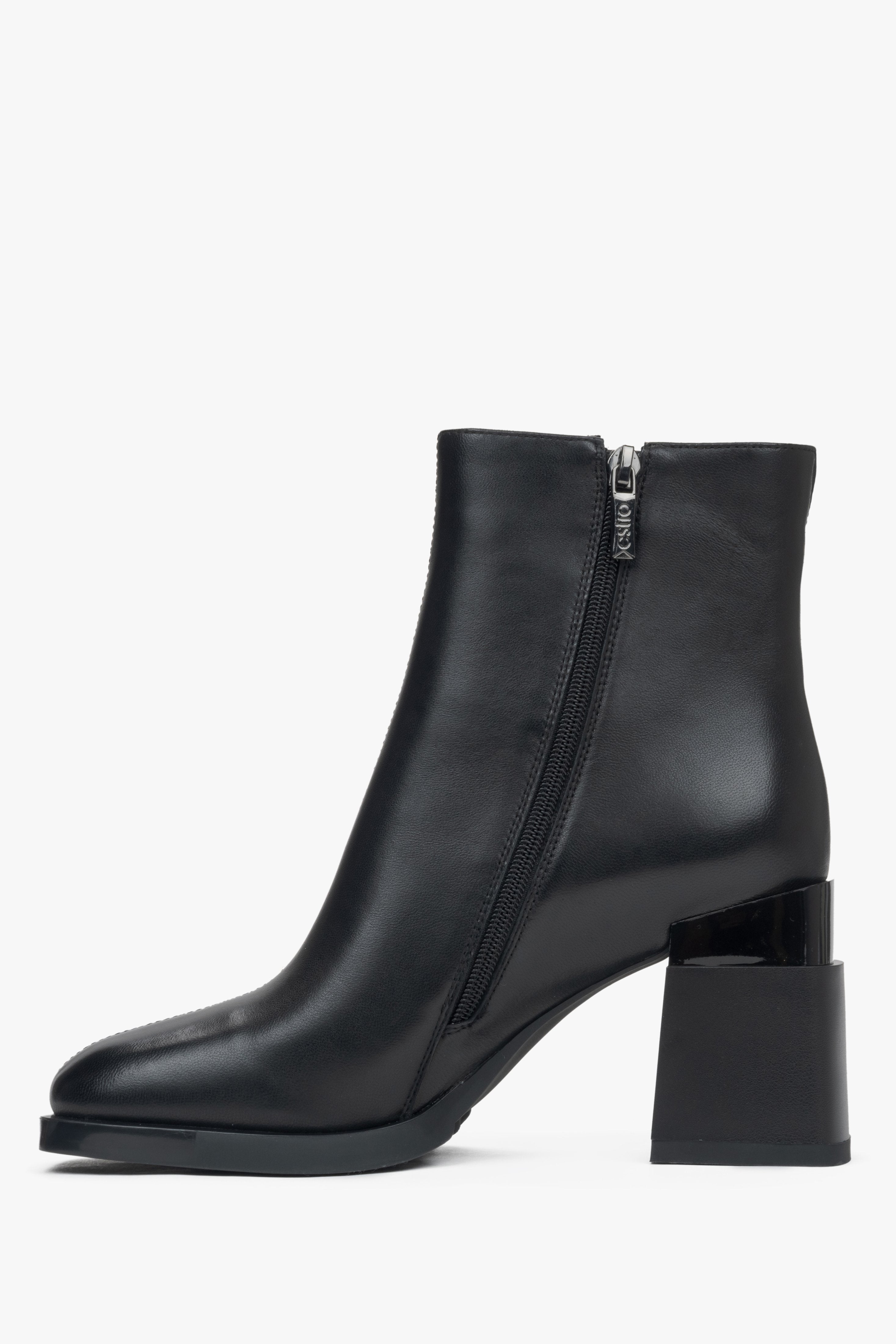 Women's black ankle boots made of genuine leather with a block heel and light insulation - side profile of the shoe.