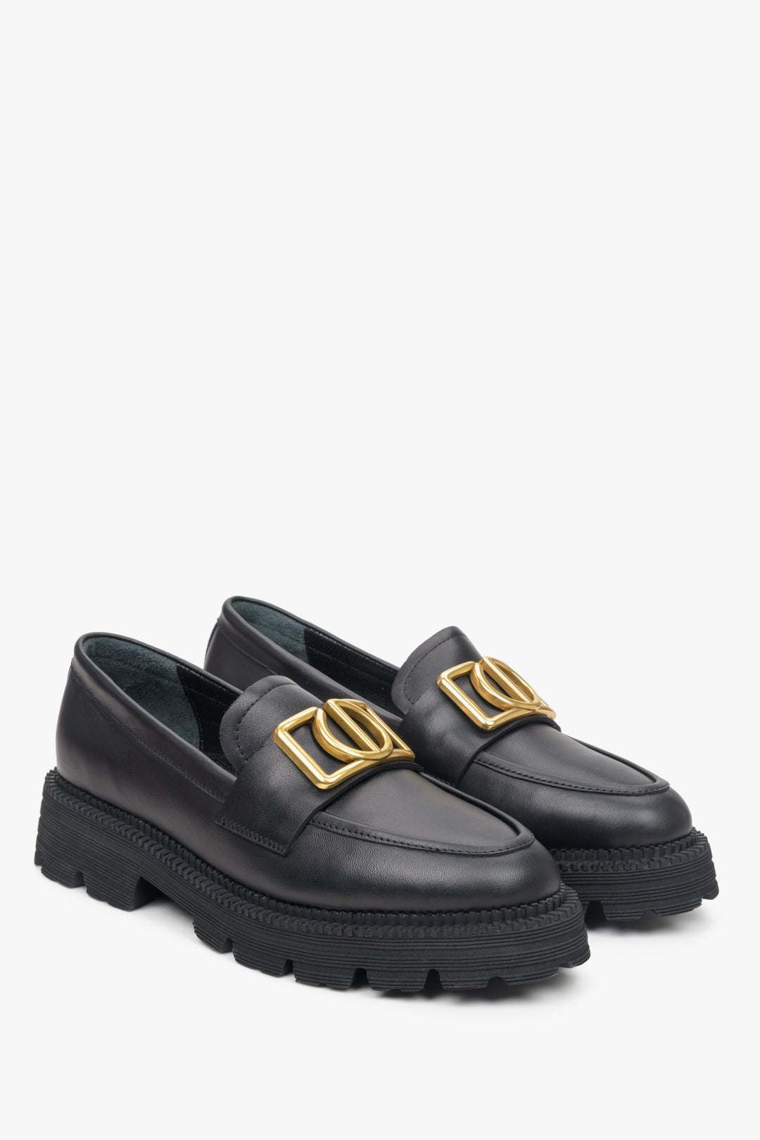Women's black loafers on a chunky platform with gold chain.