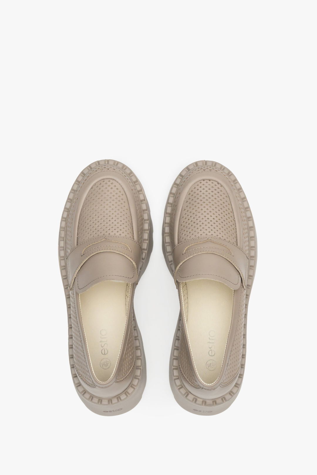 Women's leather loafers with perforation in beige color - shoe presentation from above.