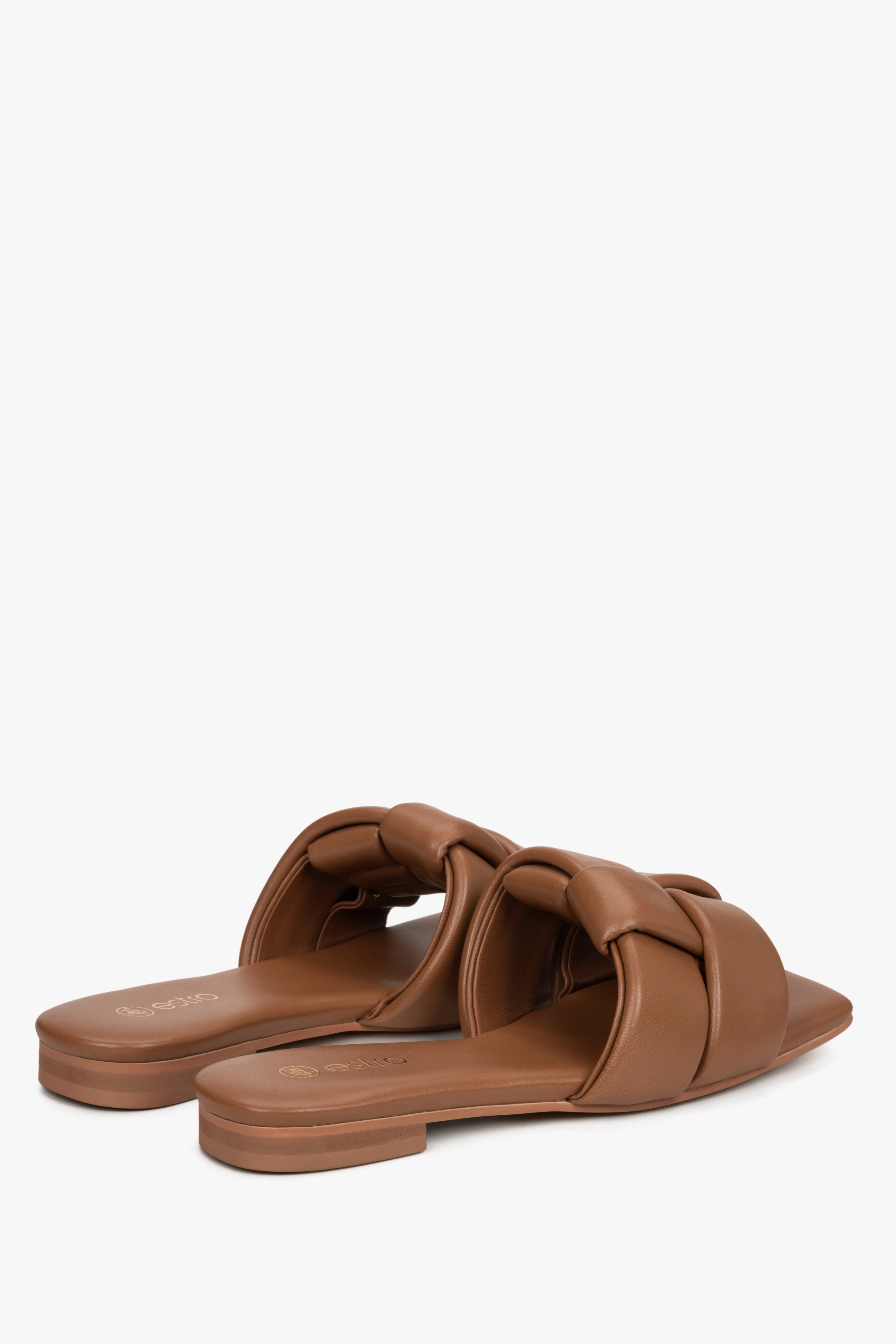 Women's brown leather slides by Estro with a flat heel.