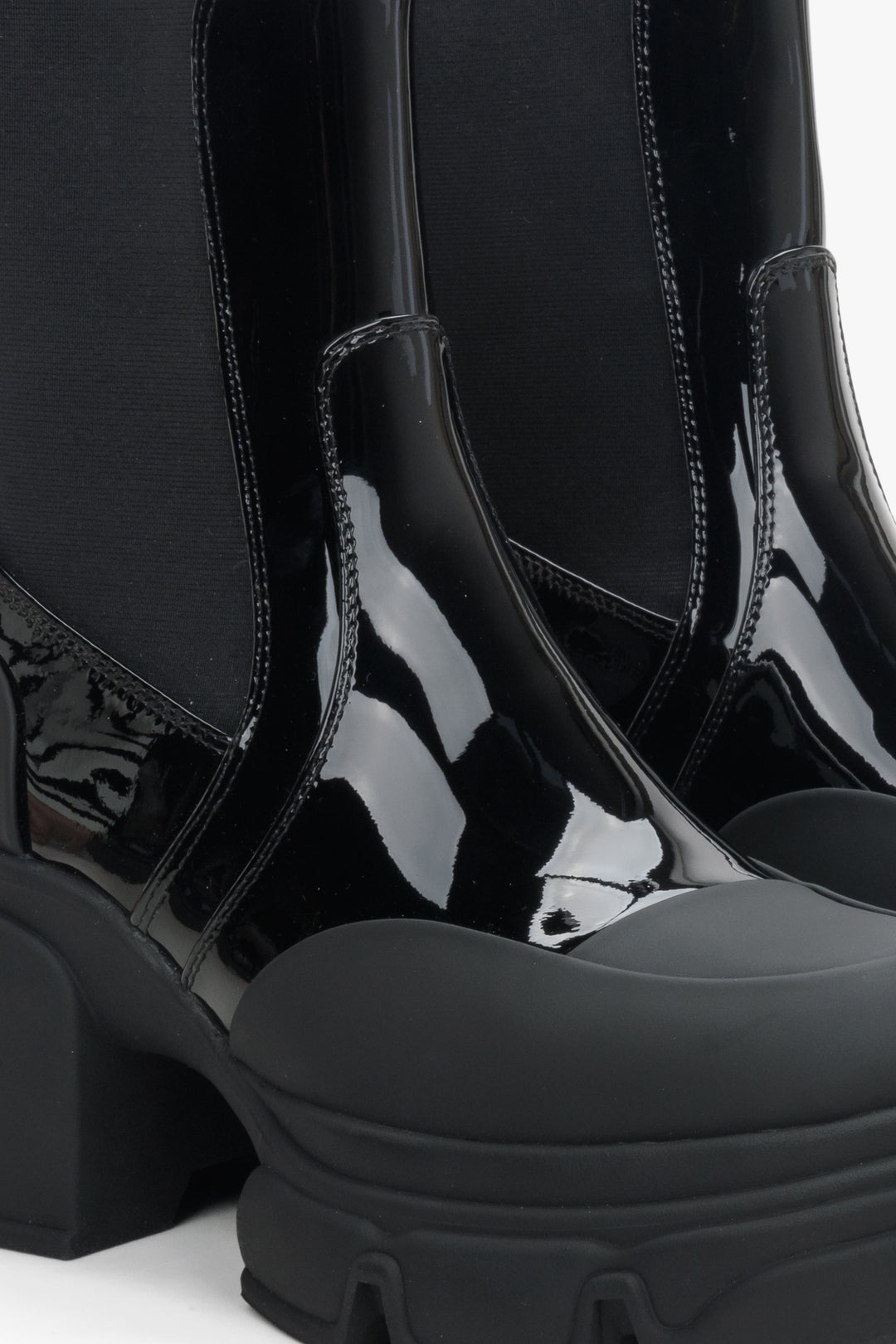 Women's black Chelsea boots by Estro made of patent natural leather - close-up on details.