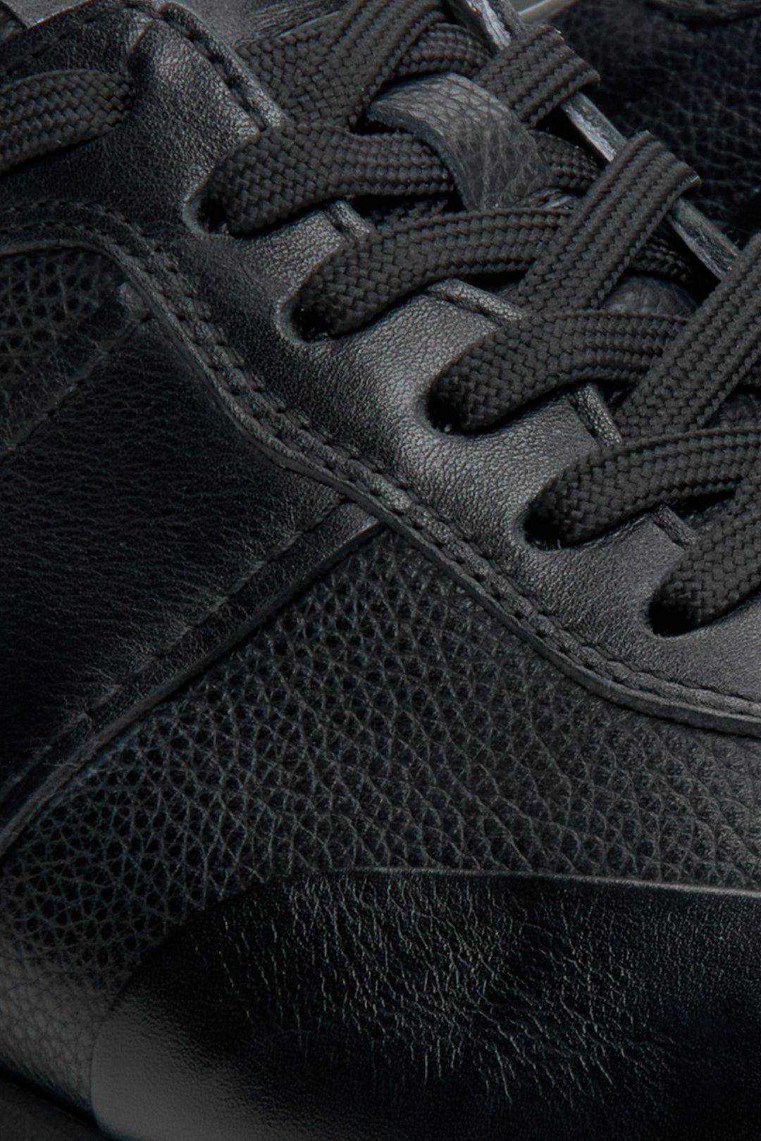 Men's black leather sneakers by Estro - close-up on details.