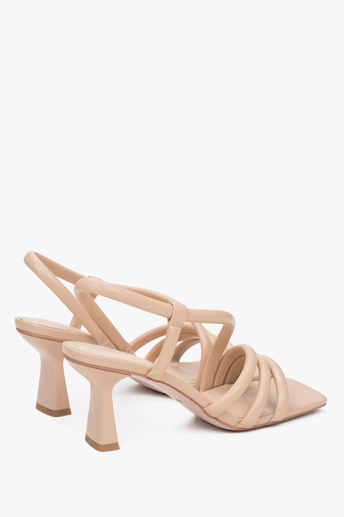 Women's beige strappy sandals made of genuine leather - a close-up on heel and shoe sideline.