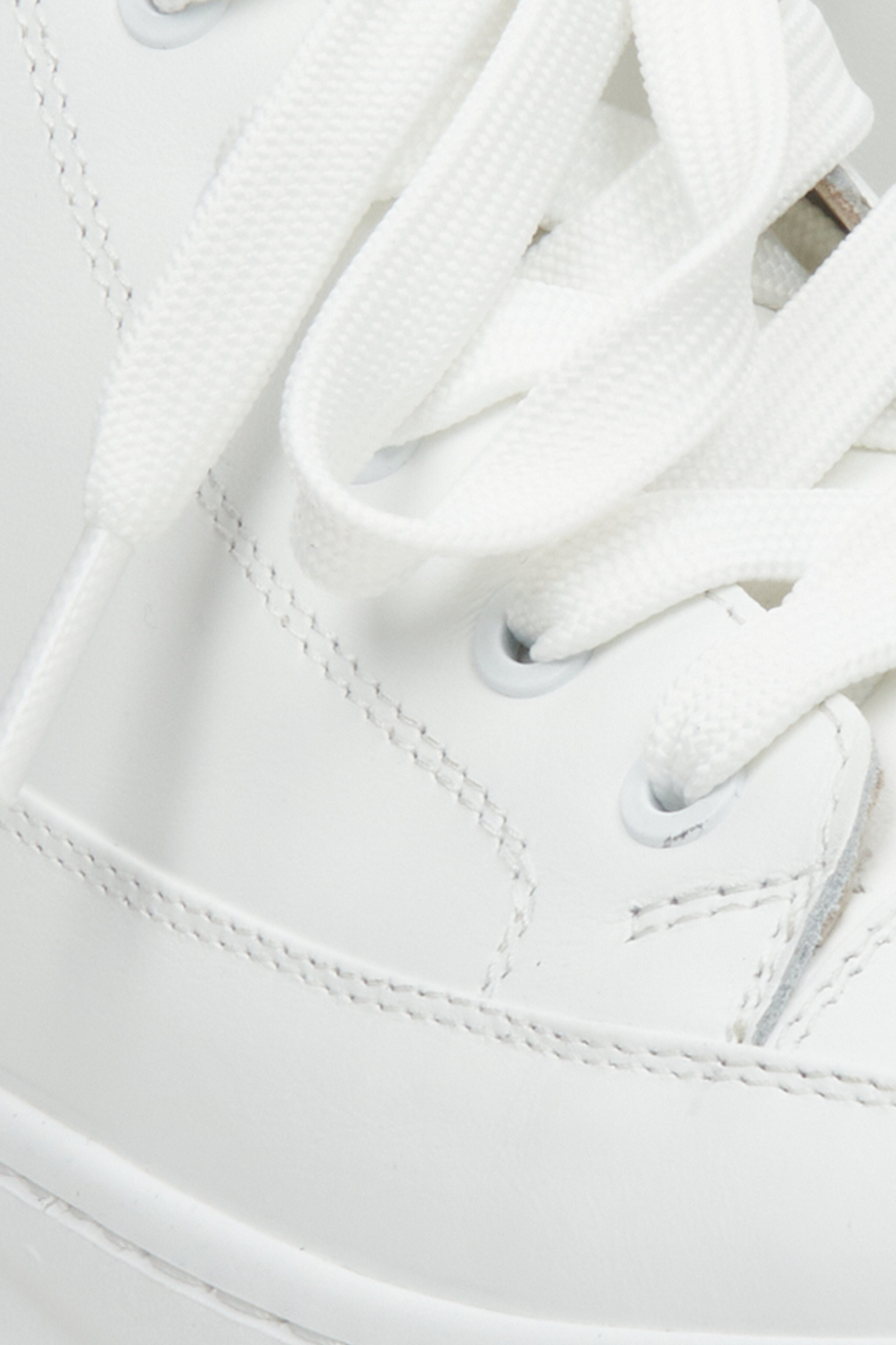 Women's white sneakers - close-up on details.