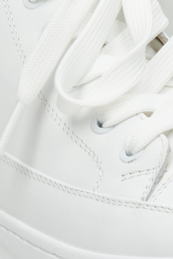 Women's white sneakers - close-up on details.