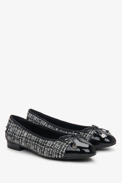 Women's black and white ballet flats made of combined materials with a bow by Estro.