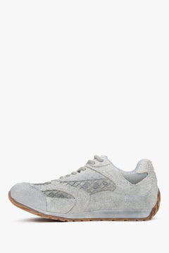 A pair of women's low-top sneakers in grey, featuring a mix of soft velour and textile panels.