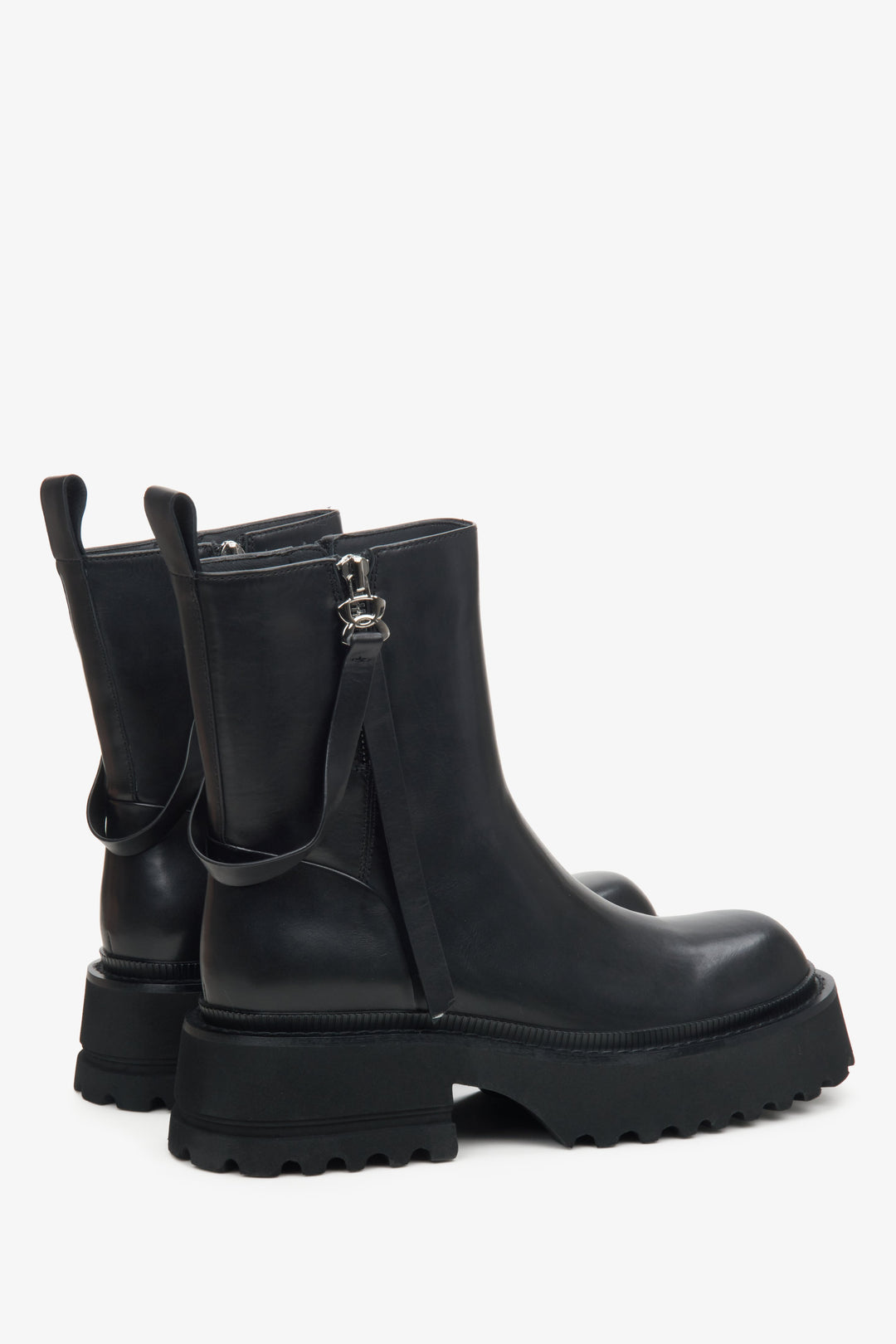 Women's black boots made of genuine leather by Estro - close-up on the side line of the shoe.