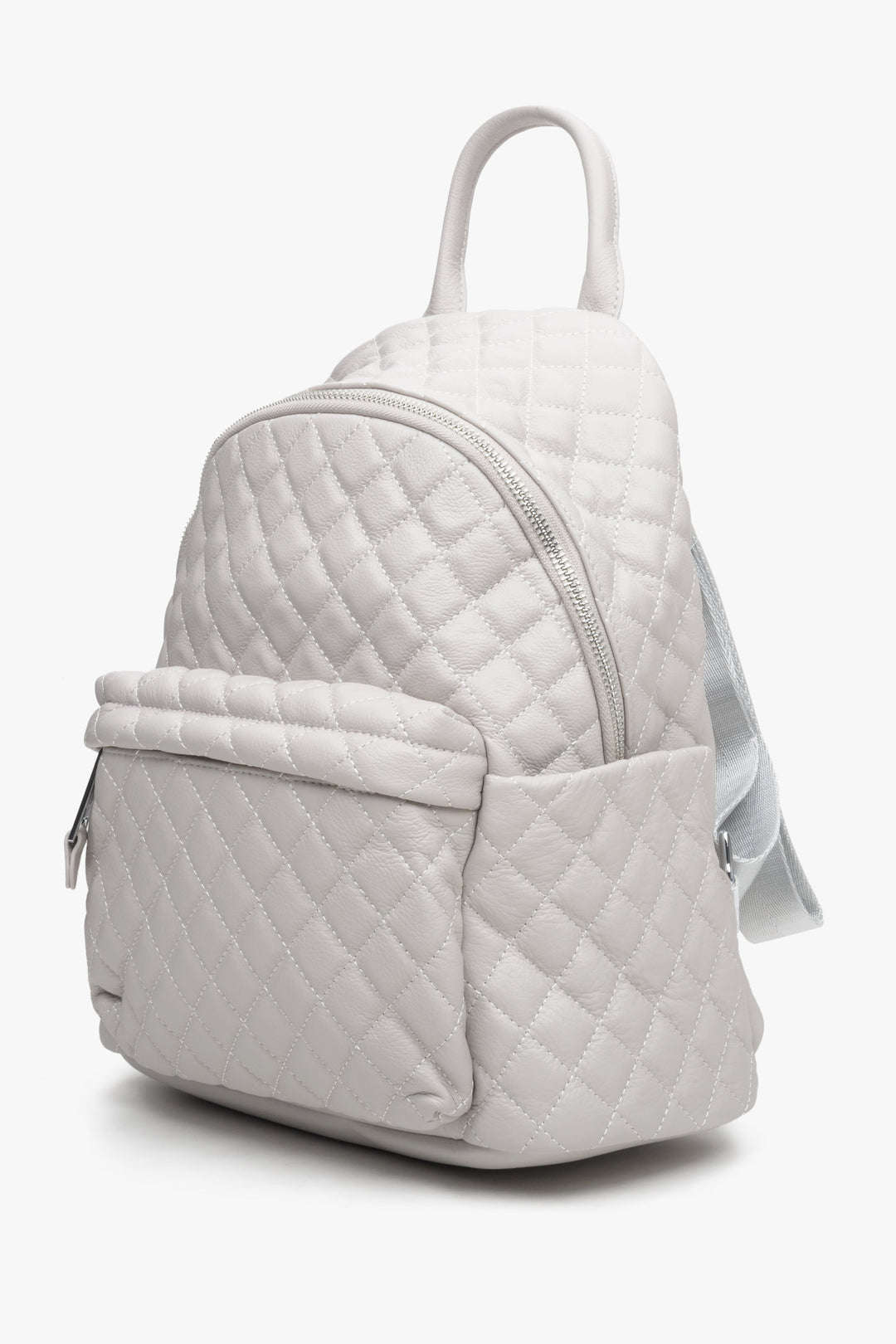 Light beige quilted leather women's backpack by Estro - side view of the model.
