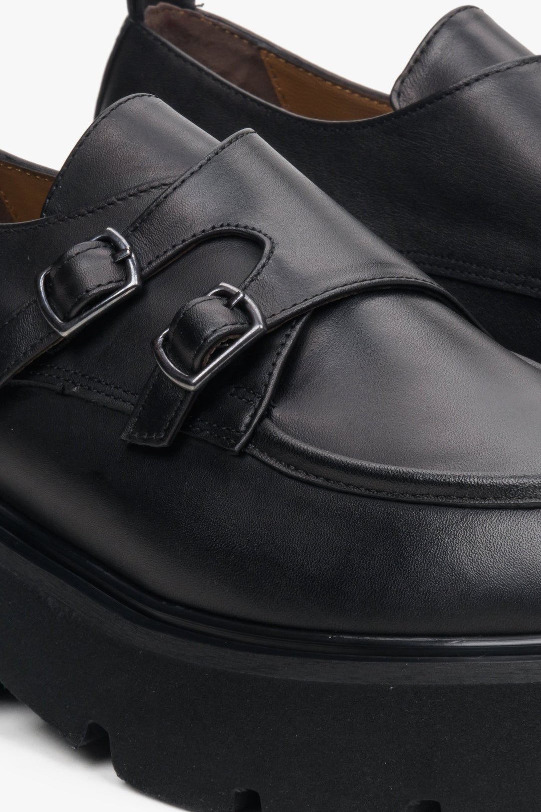 Women's black leather shoes by Estro with a decorative buckle - close-up on the detail.
