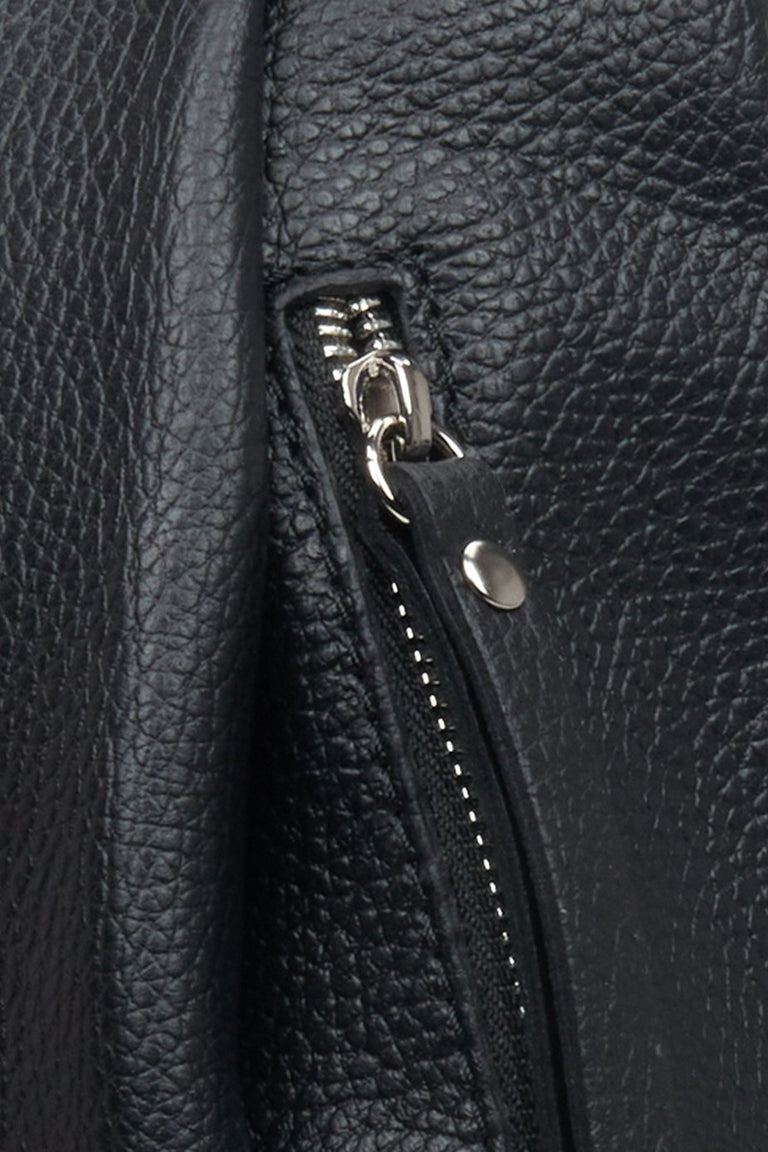 Elegant women's black backpack - close-up on details.