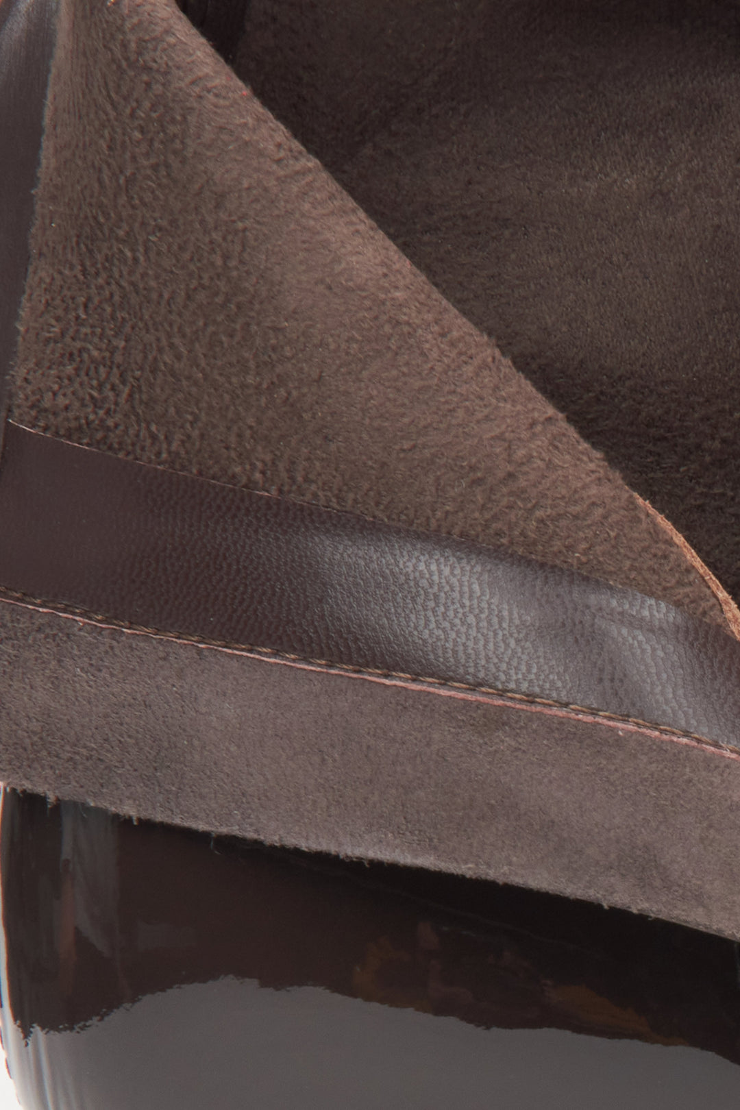 Dark brown patent leather women's ankle boots on a stiletto heel by Estro – close-up of the interior of the shoe.