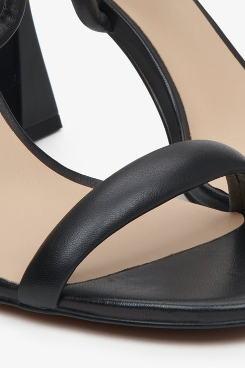 Women's black strappy sandals on a funnel heel, Estro brand. Close-up on details.