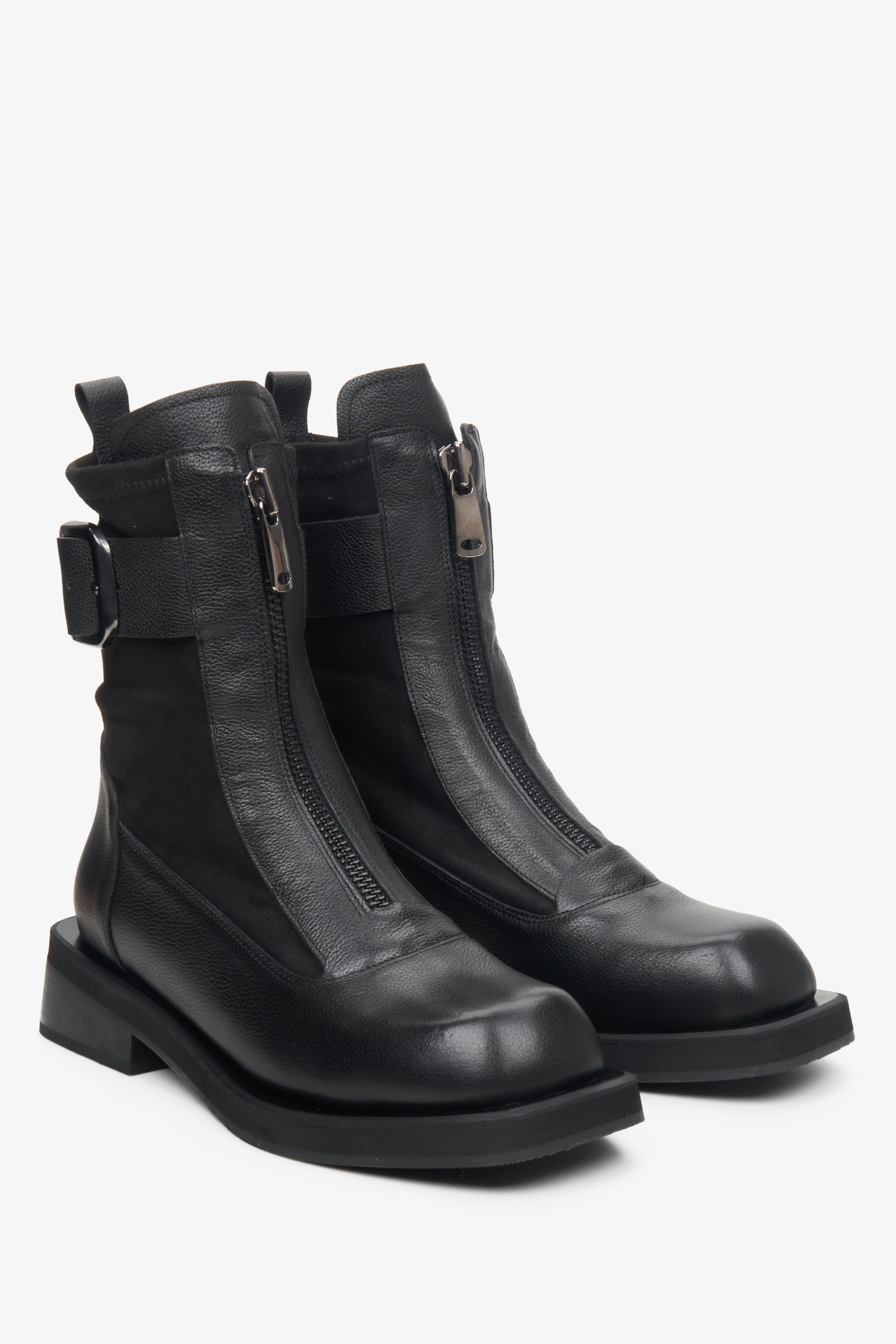 Women's black leather ankle boots with buckle and elastic upper.