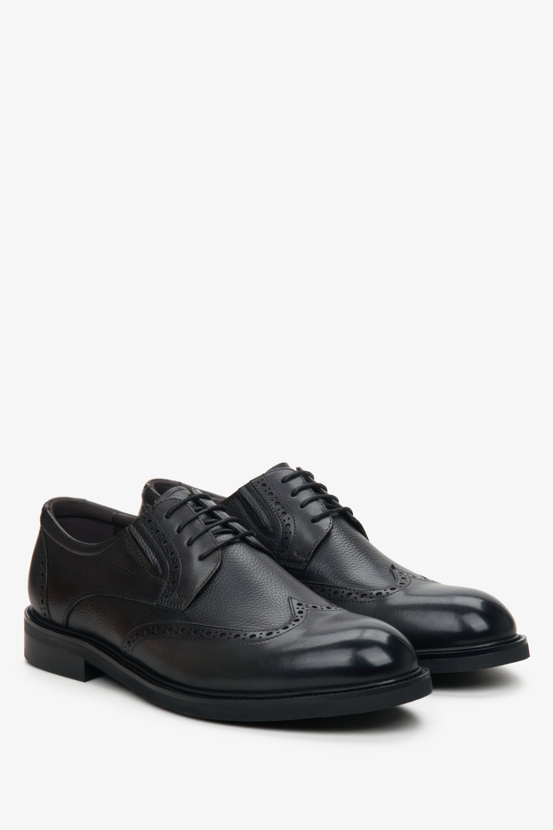 Men's black leather brogues by Estro with decorative perforations.