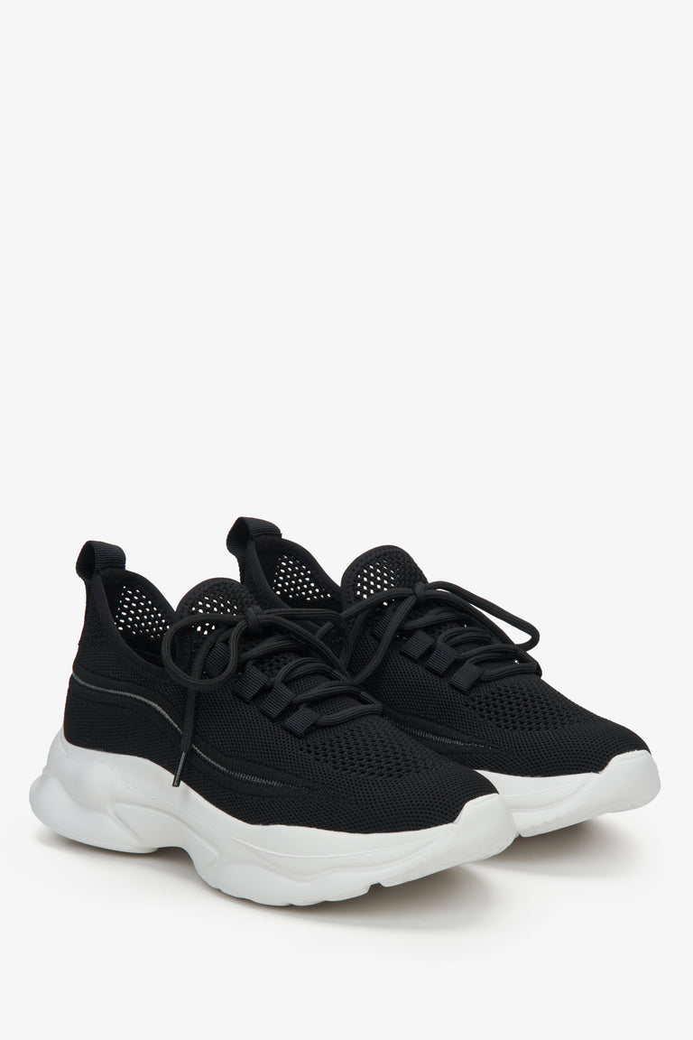 Low-top mesh and textile women's sneakers in black.