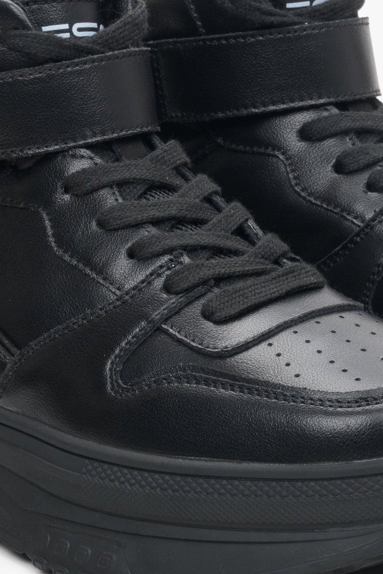 High-top women's sneakers ES8 made of genuine leather in black colour - close-up on details.