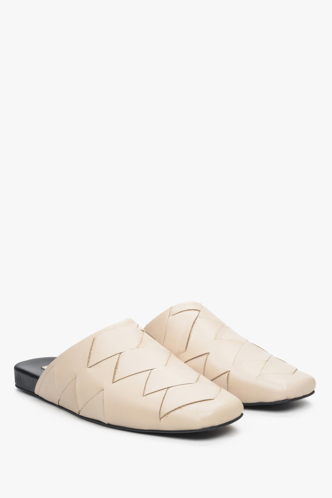 Women's light beige leather slides with a covered toe line.