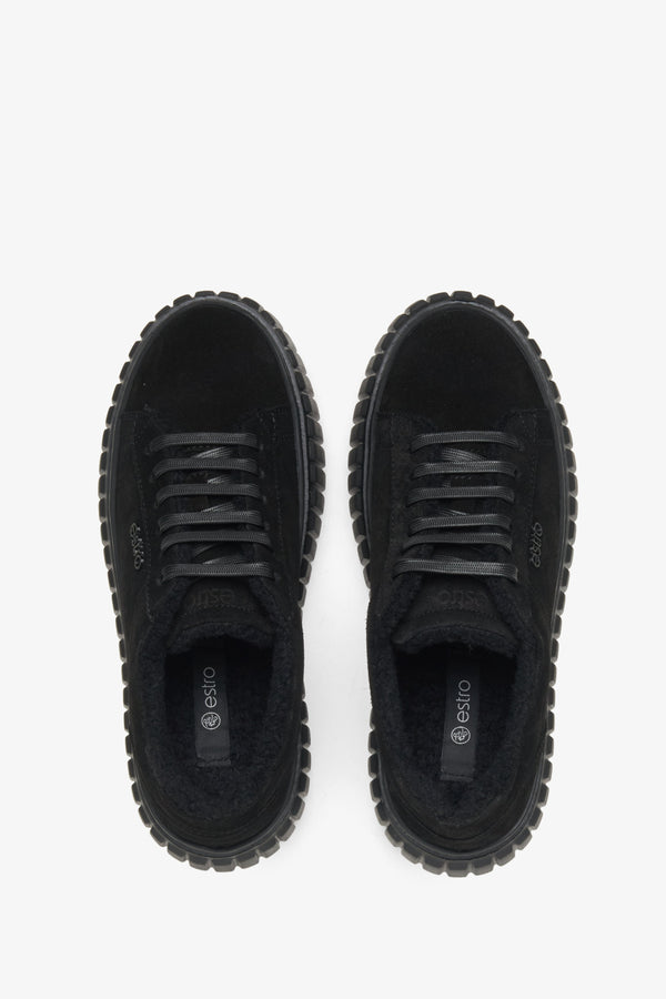 Women's black leather low-top sneakers with sealing.