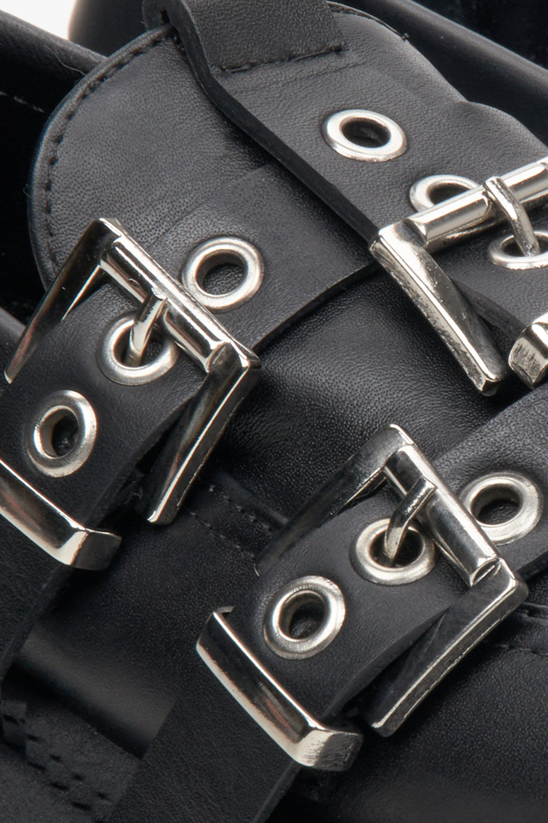 Women's black leather loafers by Estro with decorative buckles - close-up on details.