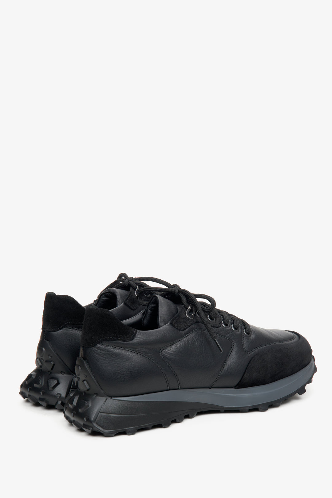 Men's black athletic sneakers with suede and leather by Estro - close-up on the side seam and heel.