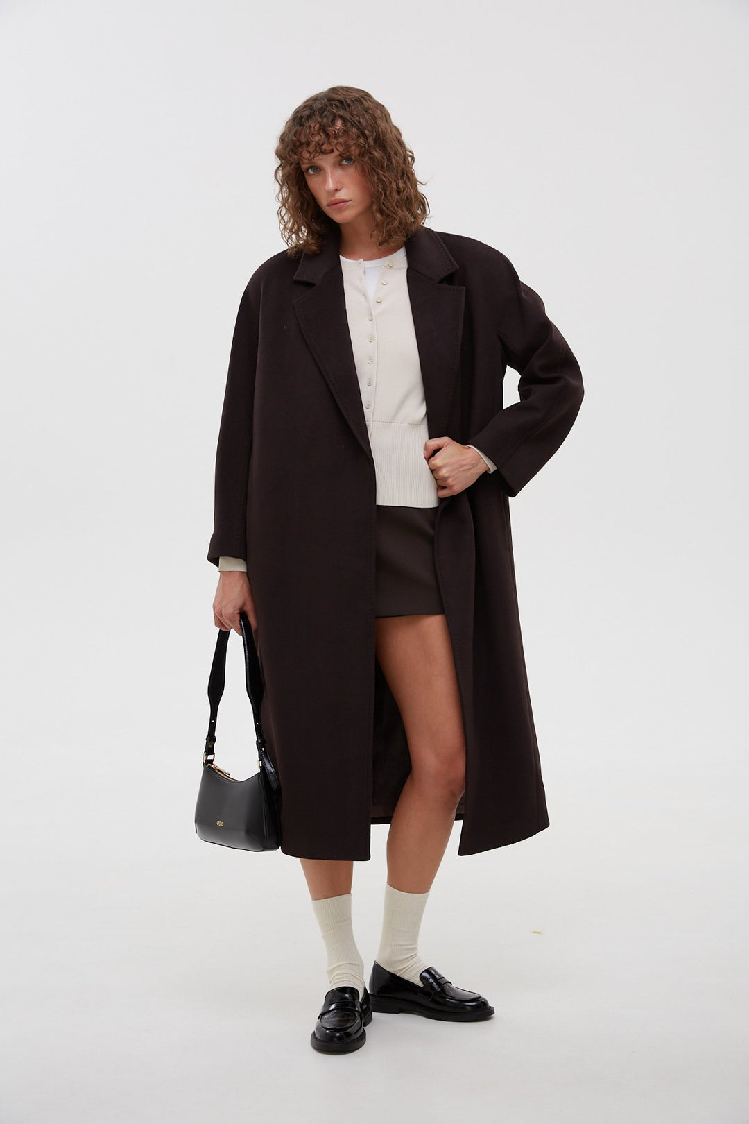 Long black bucket coat tied at the waist.