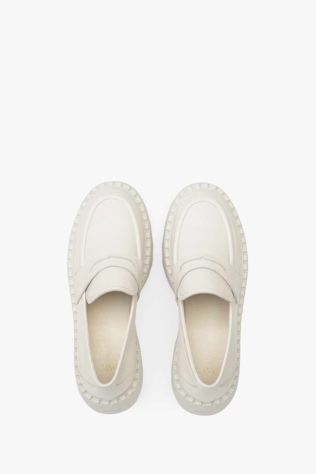 Elegant leather loafers in light beige - presentation of the footwear from above.